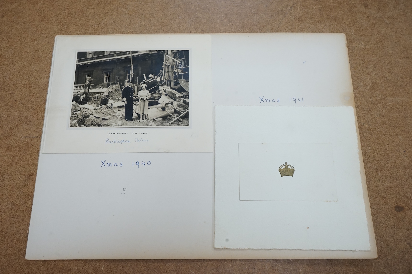 Two Royal Christmas cards; a card for Christmas 1940, the image used being a photograph of HM King George VI and Queen Elizabeth against a backdrop of the bomb damage at Buckingham Palace, dated ‘September 10th 1940’ (un